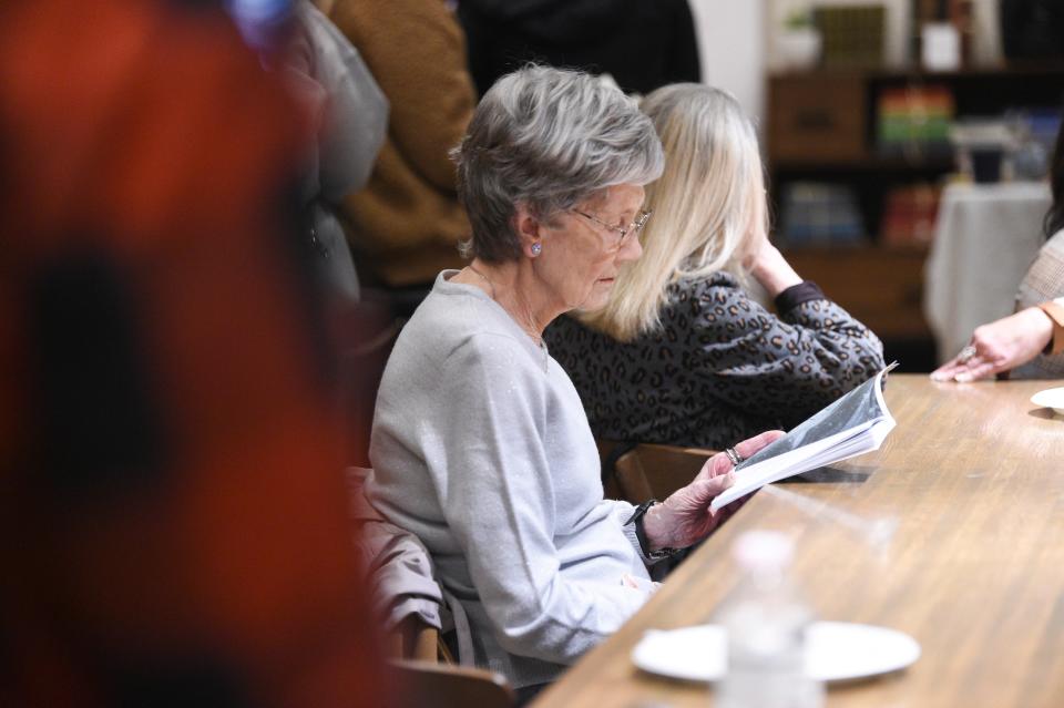 Barbara Carr reads at author Audra McElyea’s book launch at Addison’s Bookstore on Gay Street, Friday, Jan. 5, 2024.