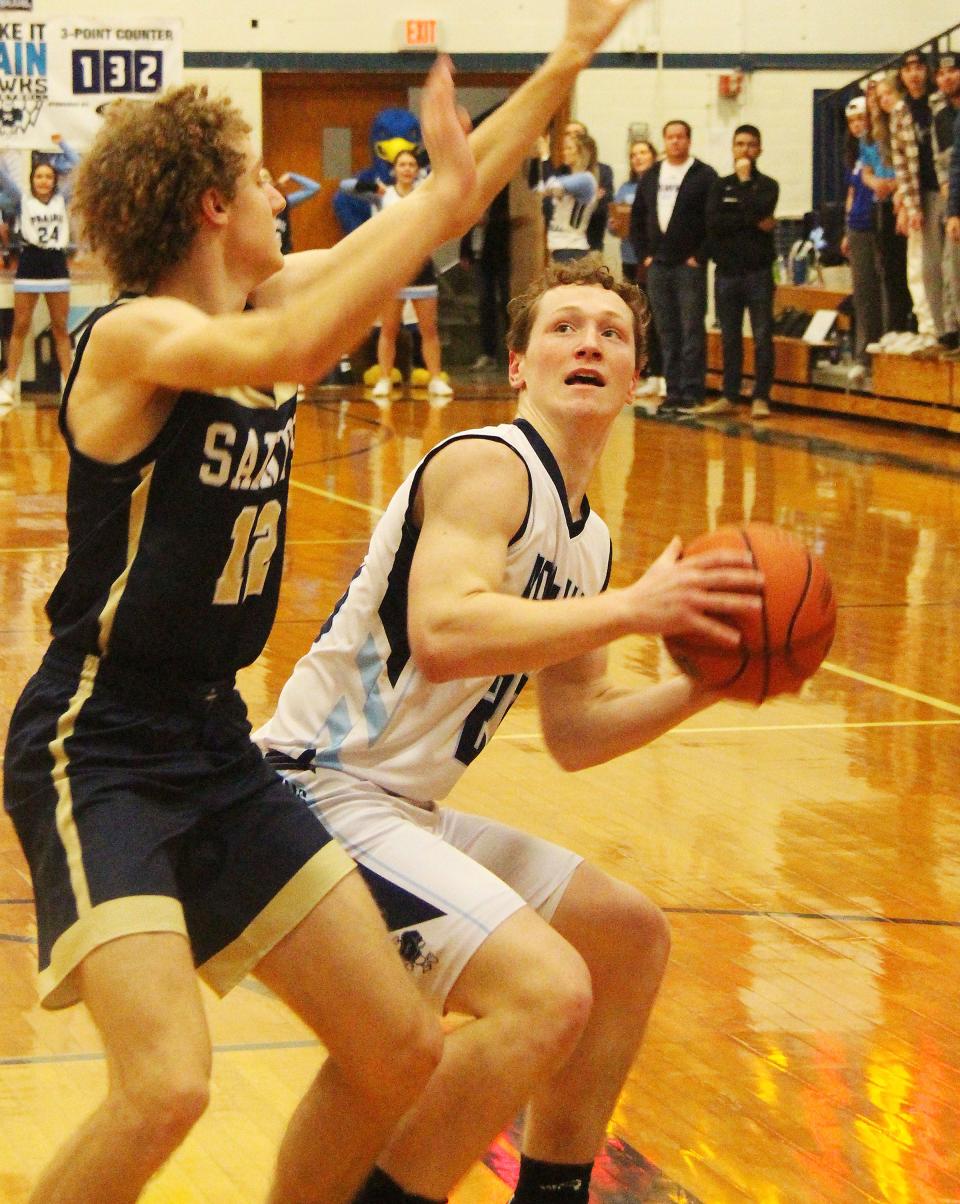 Prairie Central'sCamden Palmore tries to take a shot against Central Catholic defender Rye Pirtz Tuesday. Palmore scored 10 points in PC's 72-66 victory.