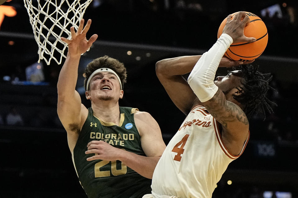 Texas guard Tyrese Hunter (4) shoots against Colorado State guard Joe Palmer (20) during the first half of a first-round college basketball game in that NCAA Tournament, Thursday, March 21, 2024, in Charlotte, N.C. (AP Photo/Mike Stewart)