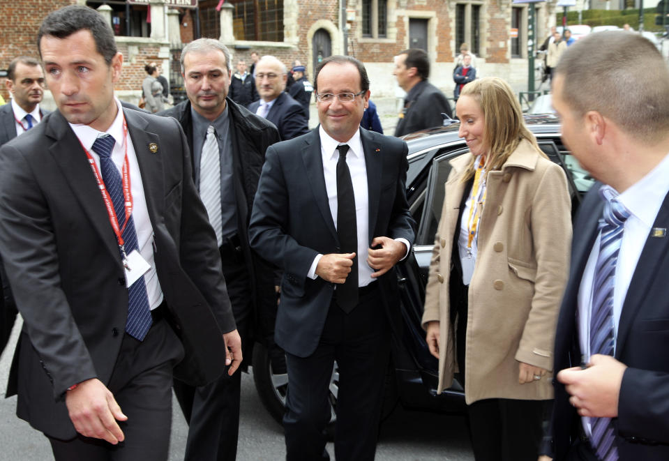 French President Francois Hollande, center, arrives for a meeting of European Socialist Party leaders prior to an EU summit in Brussels on Thursday, Oct. 18, 2012. European leaders are gathering again in Brussels to discuss how to save the euro currency from collapse and support countries facing too much debt and not enough growth. (AP Photo/Yves Logghe)