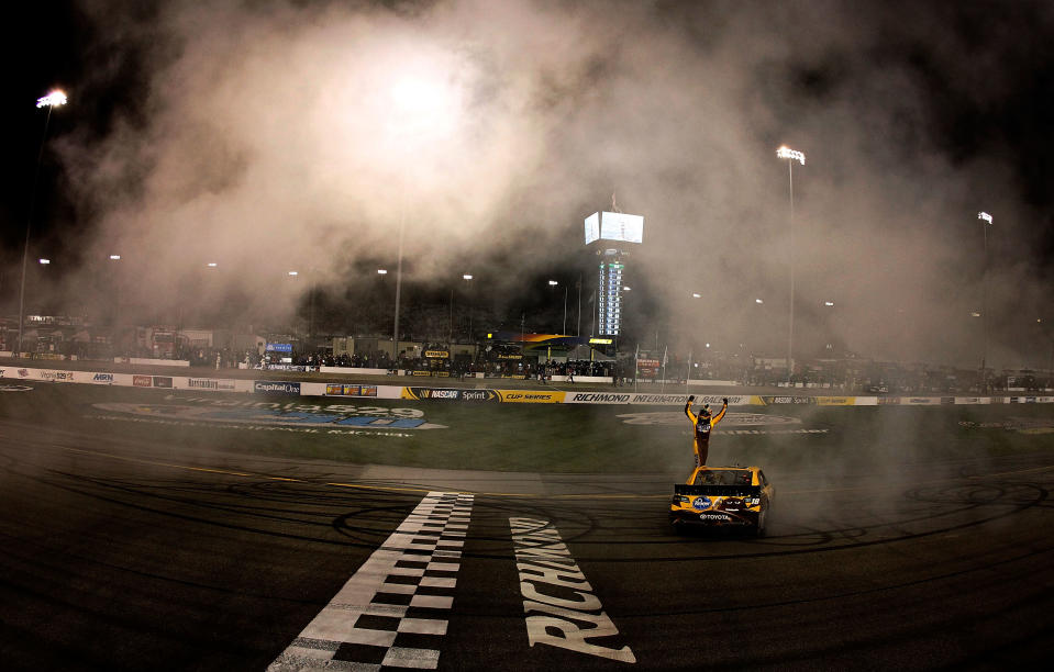 RICHMOND, VA - APRIL 28: Kyle Busch, driver of the #18 M&M's Ms. Brown Toyota, celebrates from his car after winning the NASCAR Sprint Cup Series Capital City 400 at Richmond International Raceway on April 28, 2012 in Richmond, Virginia. (Photo by Tom Pennington/Getty Images for NASCAR)