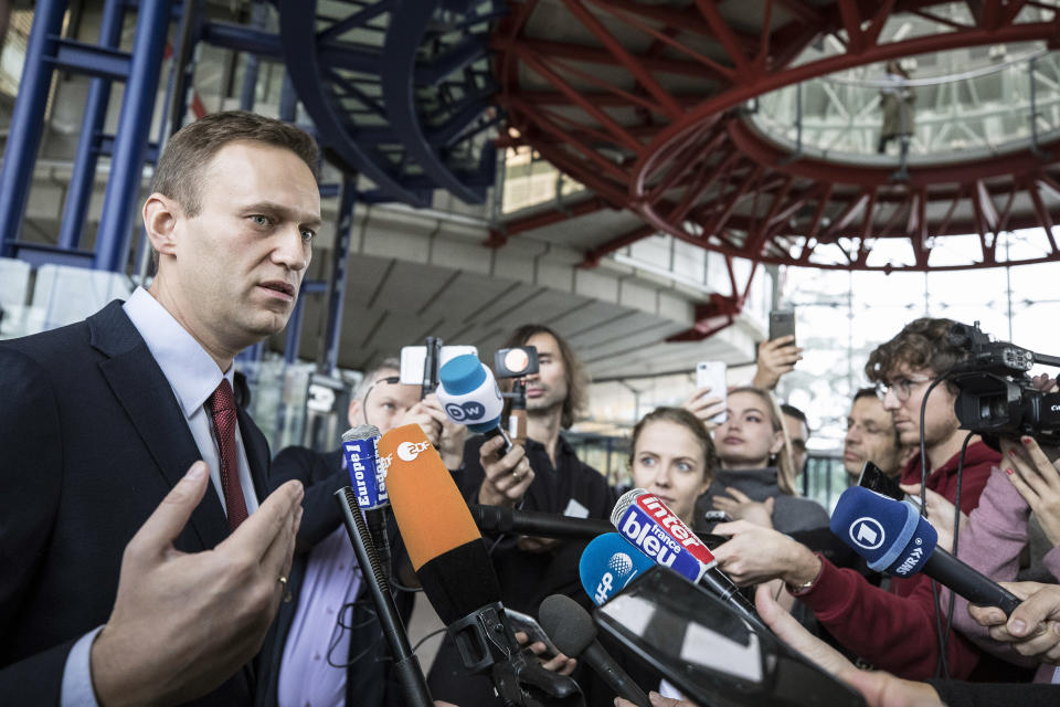 Russian opposition leader Alexei Navalny answers journalists after the European Court of Human Rights ruled his case in Strasbourg, eastern France, Thursday, Nov.15, 2018. The European Court of Human Rights has ruled that Russian authorities' repeated arrests of opposition leader Alexei Navalny were politically driven. (AP Photo/Jean-Francois Badias)