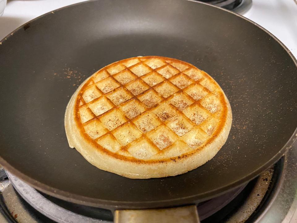 a frozen waffle in a frying pan