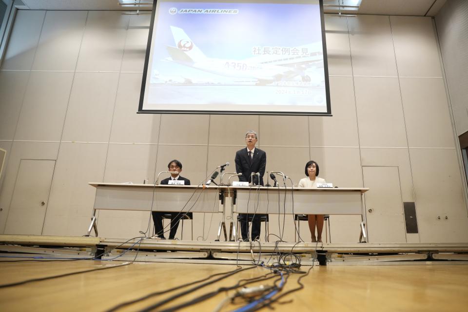 Yuji Akasaka, center, President and CEO of Japan Airlines, is introduced during a press conference in Tokyo, Wednesday, Jan. 17, 2024. Japan Airlines has named Mitsuko Tottori as its first woman president following a collision between one of its planes and a coast guard aircraft during Japanese New Year holidays that left five dead. Tottori will replace JAL president and CEO Yuji Akasaka, who will take over as chairman. (AP Photo/Eugene Hoshiko)