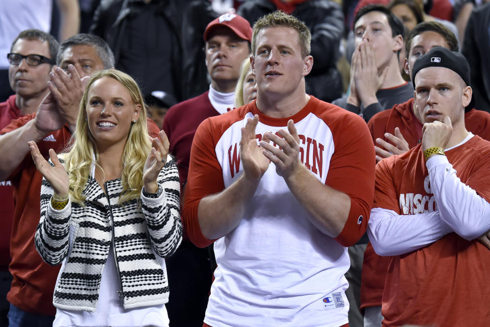 April 6, 2015: Former Wisconsin Badgers football player and current NFL star JJ Watt (middle) and Tennis star Caroline Wozniacki watches his team play during the first half of the Wisconsin Badgers game versus the Duke Blue Devils in the NCAA Division I Men's National Championship at Lucas Oil Stadium in Indianapolis, IN. (Photo by Robin Alam/Icon Sportswire/Corbis via Getty Images)