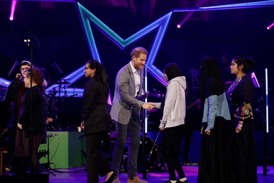 Prince Harry presents the Health and Wellbeing category award to members of the