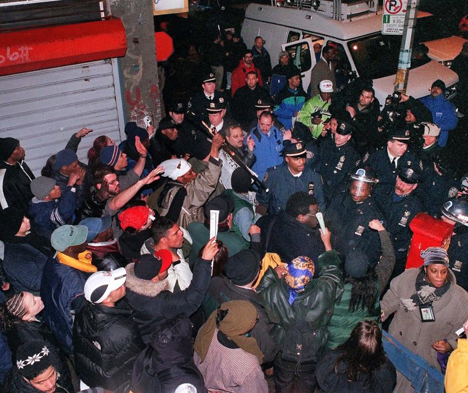 A loud but mostly nonviolent group of demonstrators are stopped by police in the Bronx section of New York on Friday, Feb. 25, 2000, as they tried to march around the block that Amadou Diallo lived on. Four New York City police officers were acquitted earlier Friday of all charges in the shooting death of Diallo in February 1999. (AP Photo/Steve Chernin)