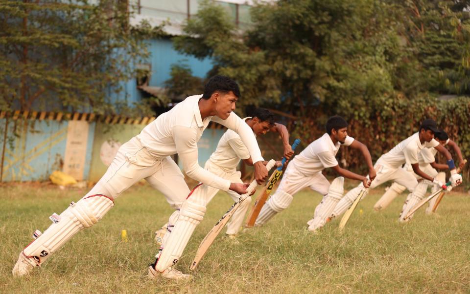 Players take part in cricket practice at Azad Maidan