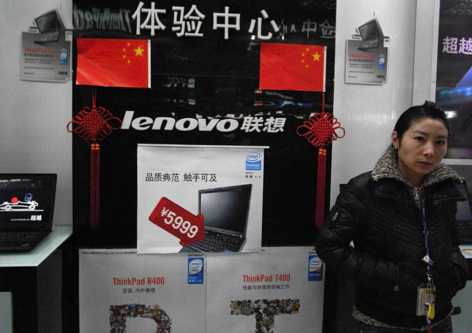 FILE - In this Jan 8, 2009, file photo, a vendor waits for customers at a computer shop selling Lenovo laptops in Beijing, China. U.S. trade officials have issued a $300 billion target list of Chinese imports including laptop computers for more tariff hikes, ratcheting up tensions with Beijing. (AP Photo/Ng Han Guan, File)