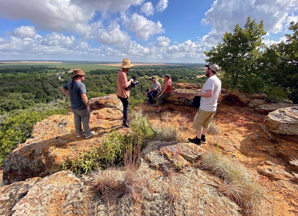 A film crew speaks with Tonkawa tribal citizen Valerie Mooney and her husband Bud atop Red Mountain in central Texas, which the Tonkawa Tribe recently purchased.