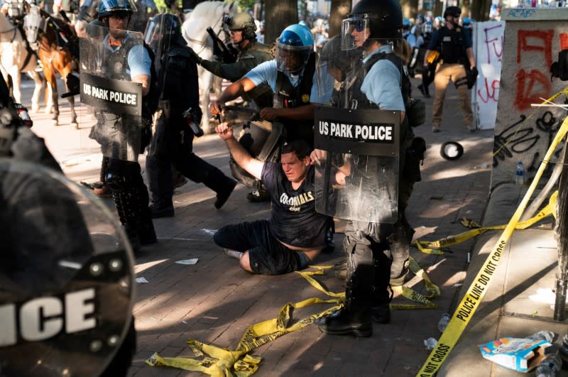 Riot police clear Lafayette Park for a photo opportunity by President Donald Trump in Washington