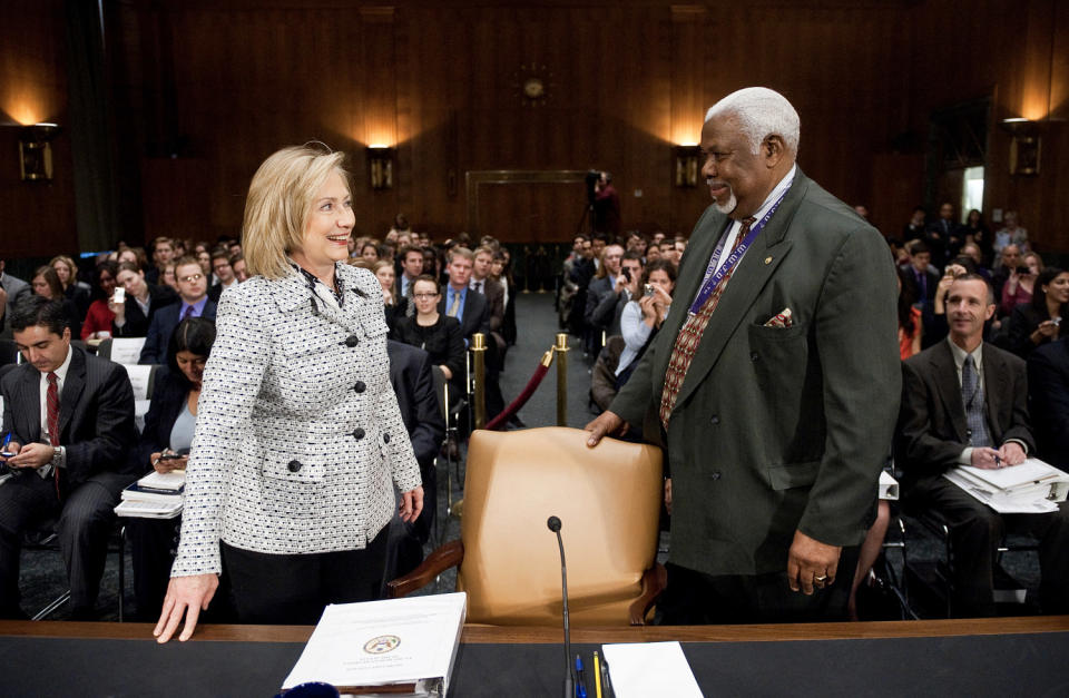 Bertie Bowman, hearing coordinator for the Senate Foreign Relations Committee, escorts Secretary of State Hillary Clinton to her seat for the Senate Foreign Relations Committee hearing on March 2, 2011. (Bill Clark / AP)