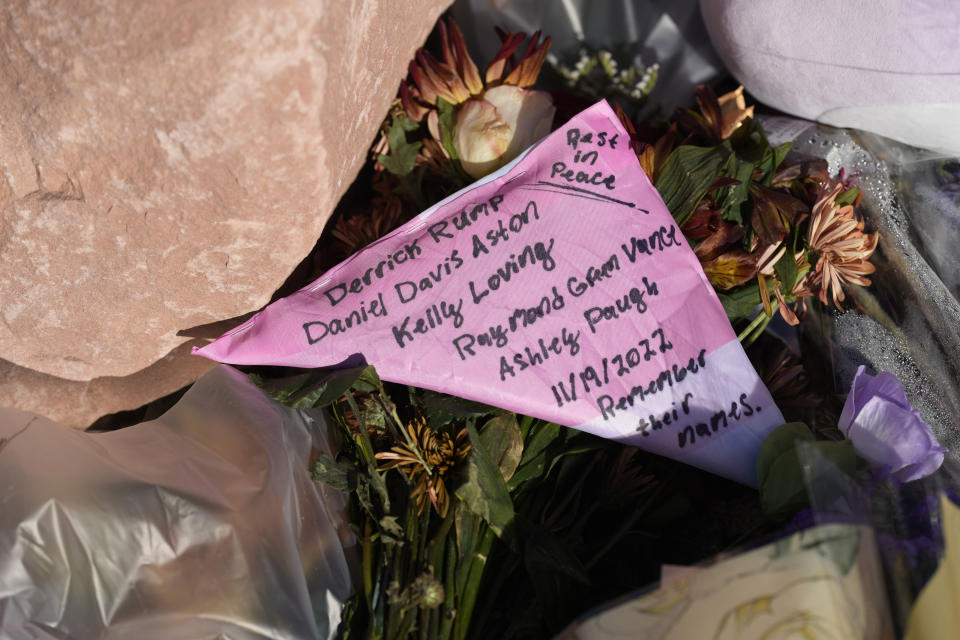 Names of the five victims are hand-written on a tribute placed at a makeshift memorial near the scene of a mass shooting at a gay nightclub Wednesday, Nov. 23, 2022, in Colorado Springs, Colo. The alleged shooter facing possible hate crime charges in the fatal shooting of five people at a Colorado Springs gay nightclub is scheduled to make their first court appearance Wednesday from jail after being released from the hospital a day earlier. (AP Photo/David Zalubowski)