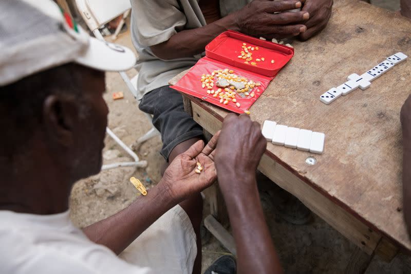 The Wider Image: In Haiti, festive wakes and Voodoo undertakers help mourners say their last goodbyes