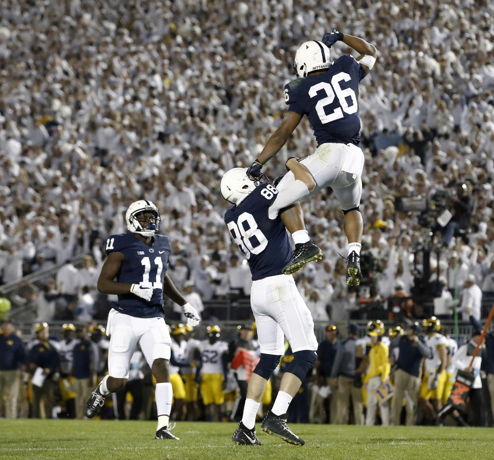 Penn State’s Saquon Barkley (26) celebrates with Mike Gesicki (88) after scoring a touchdown against Michigan during the second half of an NCAA college football game in State College, Pa., Saturday, Oct. 21, 2017. Penn State won 42-13. (AP Photo/Chris Knight)