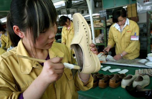 File picture of a factory worker gluing leather shoes at the Kangnai shoe factory in Wenzhou. In recent days, the name of a mid-sized Chinese coastal city has percolated through official Washington as quickly as a viral photograph of a nude Congressman