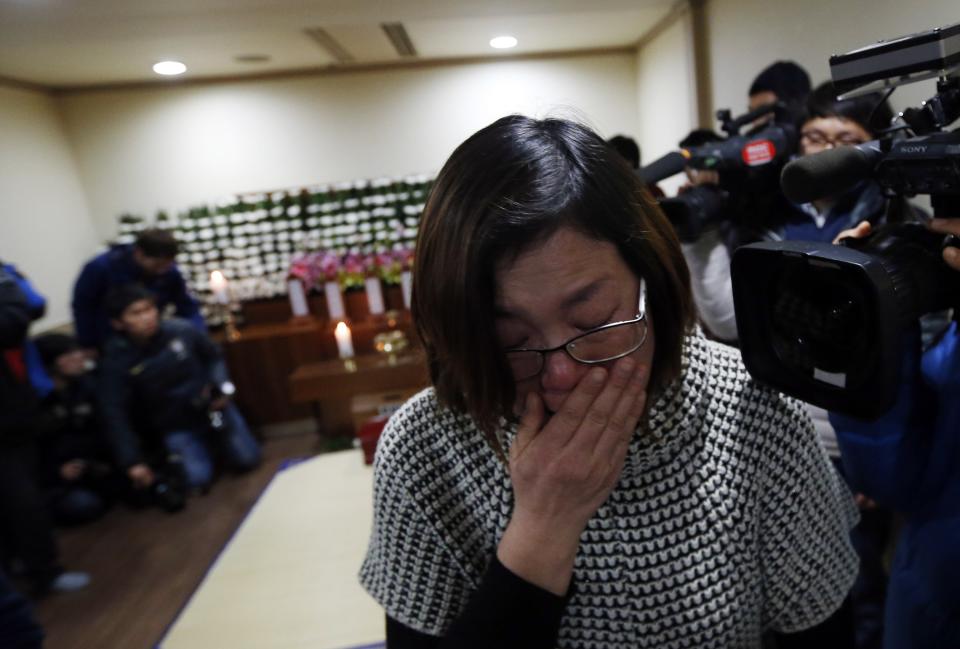 A relative of a victim who was killed when a resort building collapsed, cries as she pays her tribute at a group memorial altar in Gyeongju