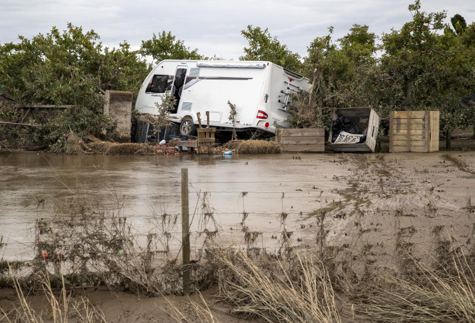 A recreation vehicle is piled on debris and surrounded by floodwater in Hawkes Bay, New Zealand, Friday, Feb. 17, 2023. Cyclone Gabrielle struck the country's north on Monday and has brought more destruction to this nation of 5 million than any weather event in decades. (Mark Mitchell/New Zealand Herald via AP)