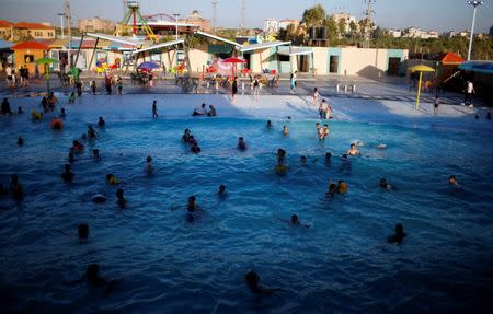 Palestinians swim at Sharm Park Water City, in Gaza July 9, 2018. Picture taken July 9, 2018. REUTERS/Mohammed Salem