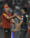 Sunrisers Hyderabad's Pat Cummins, left, congratulates Gujarat Titans' captain Shubman Gill after Gujarat Titans won the Indian Premier League cricket match against Sunrisers Hyderabad in Ahmedabad, India, Sunday, March 31, 2024. (AP Photo /Ajit Solanki)