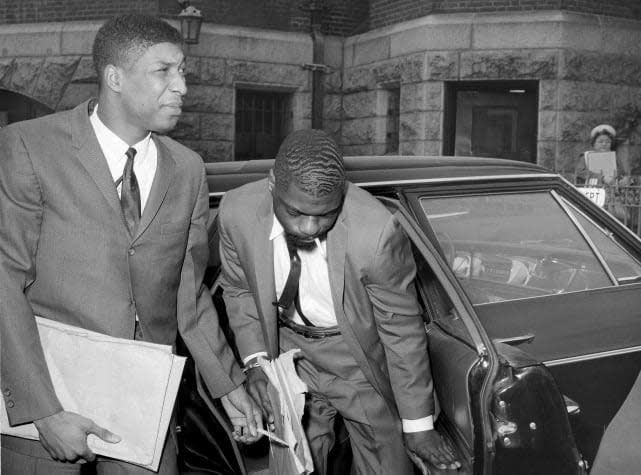 FILE – Co-defendants, from left, John Artis and Rubin “Hurricane” Carter, right, arrive at Pasaic County Courthouse Annex in Paterson, N.J., May 25, 1967. Artis, who was wrongly convicted with boxer Carter in a triple murder case that was publicized in a 1975 song by Bob Dylan and a 1999 film starring Denzel Washington, has died, Artis died at 75 on Nov. 7, 2021 of a gastric aneurysm at his home in Hampton, Va., said Fred Hogan, a longtime friend who who worked to help overturn the convictions of Artis and Carter. (AP Photo/Anthony Camerano, File) (Anthony Camerano,Copyright 2021 The Associated Press. All rights reserved.)