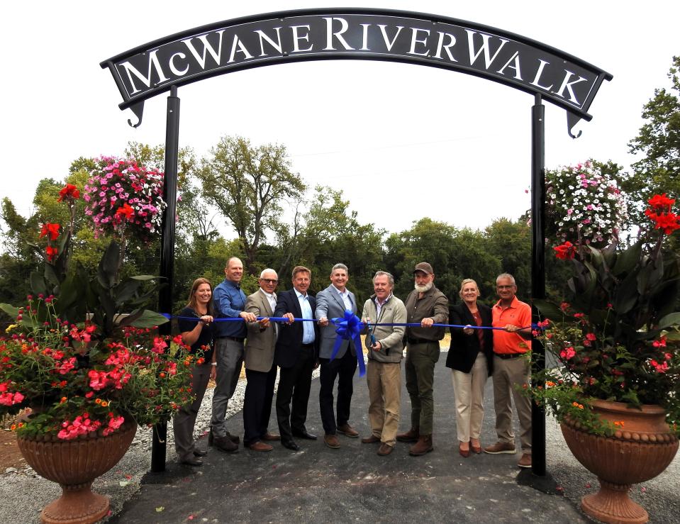 Local officials and representatives of McWane Ductile participate in a ribbon cutting for the now open McWane River Walk near Skip's Landing on County Road 1A.