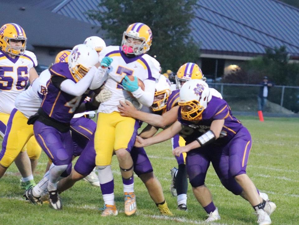 Bay Path's Kaiden Brochu tries to break through a swam of Monty Tech players during a game last season.