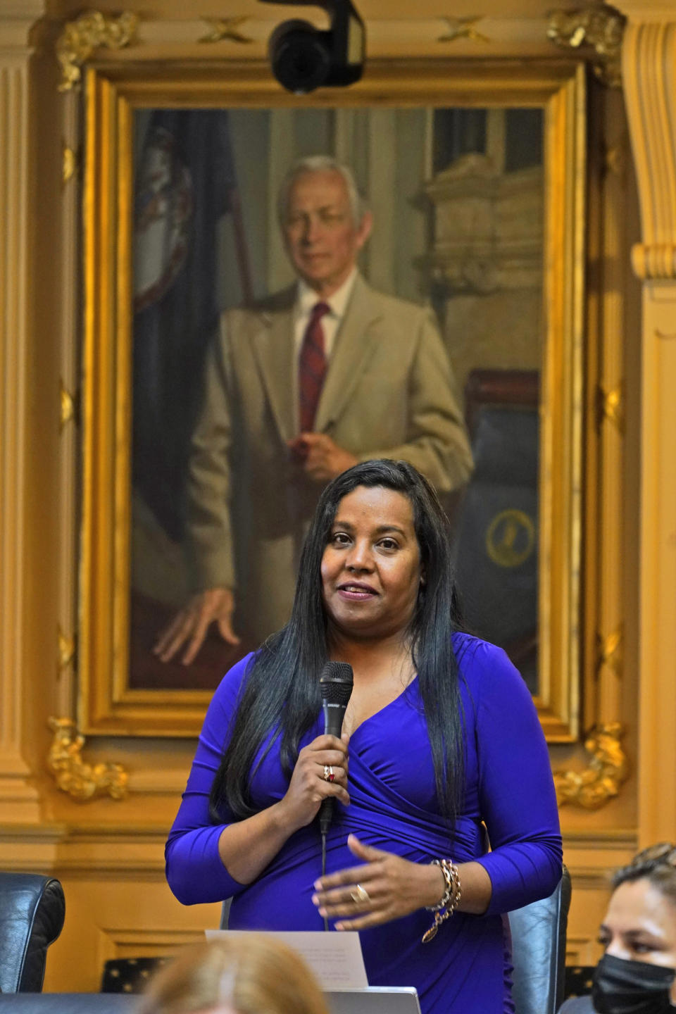 Del. Charniele Herring, D-Alexandria, gestures under the watchful gaze of the portrait of former speaker A.L. Philpott during the session at the Capitol Tuesday Feb. 8, 2022, in Richmond, Va. Republicans in the Virginia House defeated measures Tuesday that would have let voters decide whether to strip legally outdated language prohibiting gay marriage from the state Constitution and automatically restore the voting rights of felons who have served their terms. (AP Photo/Steve Helber)