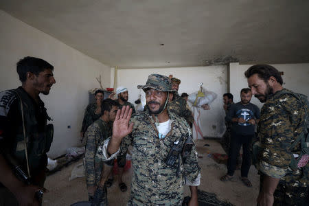 Fighter of Syrian Democratic Forces (SDF) are seen in the eastern of Deir al Zor, Syria September 12, 2017.REUTERS/ Rodi Said