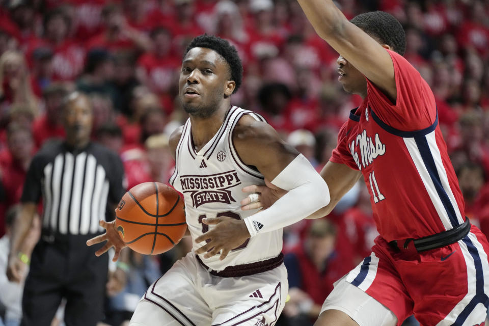 Mississippi guard Matthew Murrell (11) reaches in to attempt to knock the ball away from Mississippi State guard Josh Hubbard (13) during the second half of an NCAA college basketball game, Tuesday, Jan. 30, 2024, in Oxford, Miss. Mississippi won 86-82. (AP Photo/Rogelio V. Solis)