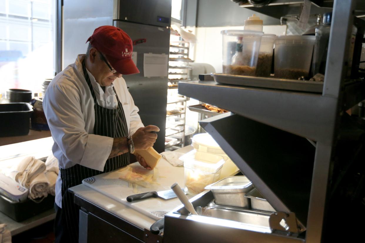 Diego Ortiz shaves the cheeses that will be used in the evening’s entrees Wednesday, Feb. 14, 2024, at the LaSalle Grill in downtown South Bend. The restaurant is one of five four-diamond establishments in Indiana as determined by the American Automobile Association (AAA).
