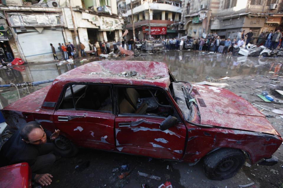 A damaged car is seen after an explosion near a security building in Egypt's Nile Delta city of Mansoura in Dakahlyia province