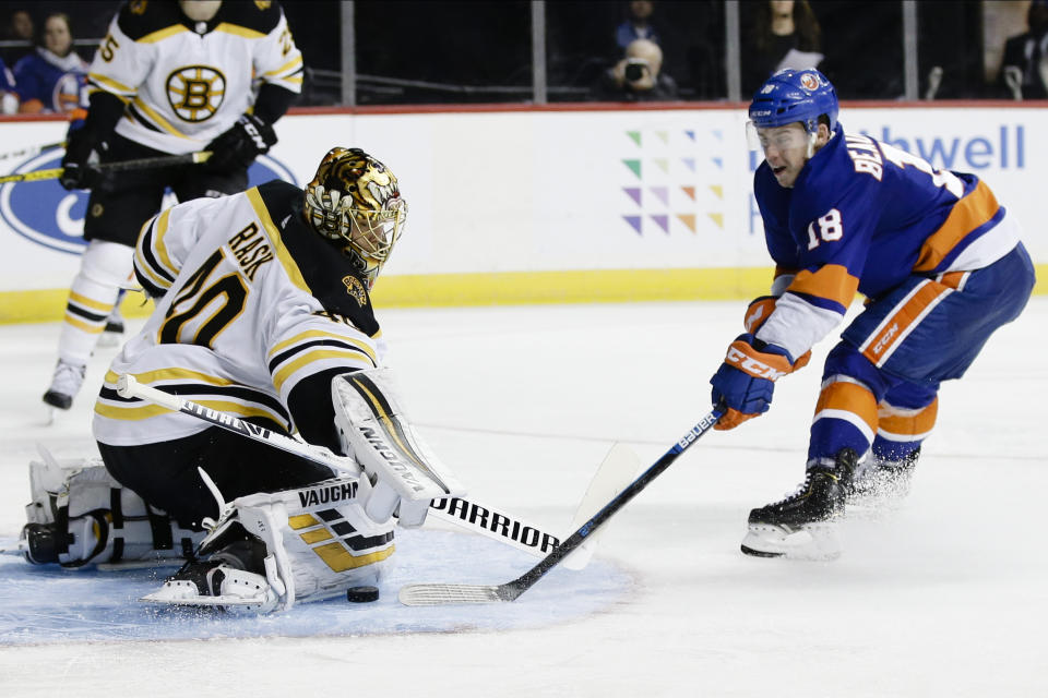 Boston Bruins goaltender Tuukka Rask (40) stops a shot on goal by New York Islanders' Anthony Beauvillier (18) during the second period of an NHL hockey game Saturday, Jan. 11, 2020, in New York. (AP Photo/Frank Franklin II)