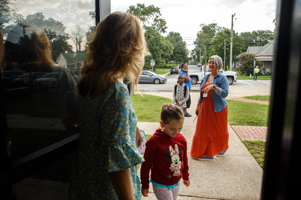 Dr. Breckon Pennell, principal of Riverside Elementary, front right, and Julie Deffenbaugh, the new teacher coach, greet children to their first day back at Riverside Elementary school in Columbia, Tenn. on Monday, Aug. 7, 2023.