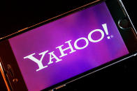 FILE - In this Dec. 15, 2016, file photo, the Yahoo logo appears on a smartphone in Frankfurt. Yahoo Japan Corp. said Thursday, Sept. 12, 2019 it will put up a tender offer, estimated at 400 billion yen ($3.7 billion), for Zozo Inc., a Japanese online retailer started by a celebrity tycoon. Yahoo Japan announced the plan which includes a business alliance with Zozo. (AP Photo/Michael Probst, File)