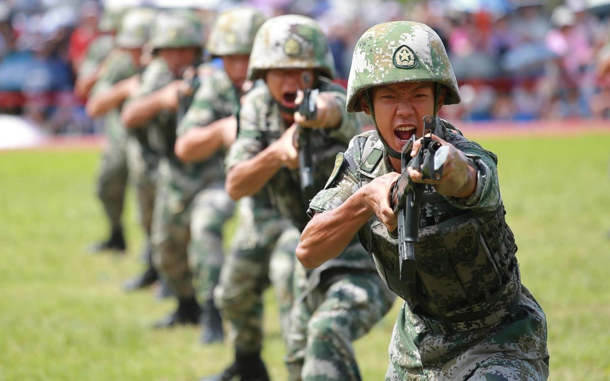 Soldiers of the People's Liberation Army (PLA) perform drills during a demonstration at an open day at the PLA Ngong Shuen Chau Barracks in Hong Kong - Visual China Group