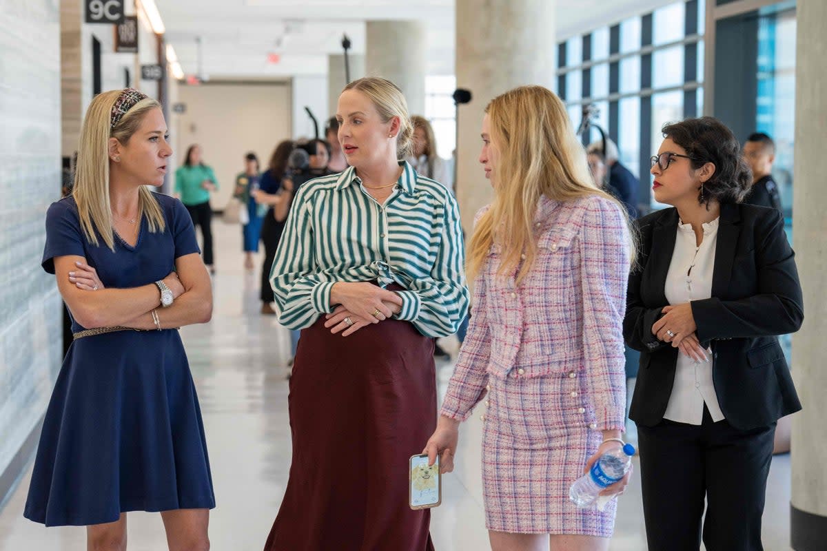 Plaintiffs Amanda Zurawski, Austin Dennard, Taylor Edwards and Elizabeth Waller appear inside a Texas courthouse on 20 July during hearings in their lawsuit against the state’s anti-abortion law (AFP via Getty Images)