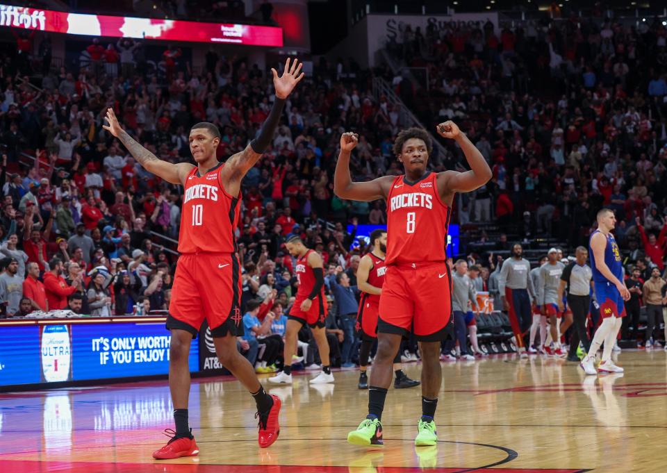 Houston Rockets forward Jabari Smith Jr. (10) and forward Jae'Sean Tate (8) celebrate their win against the Denver Nuggets at Toyota Center.