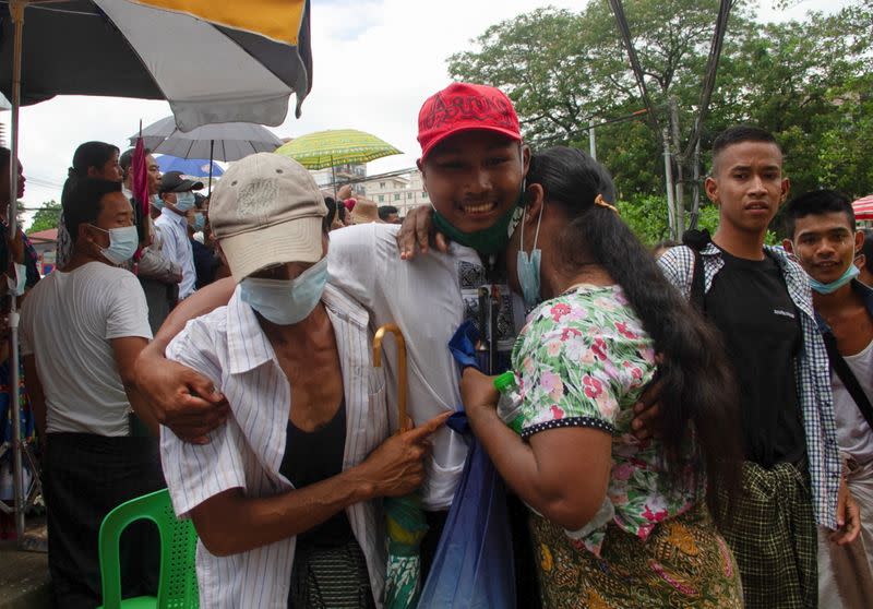 A released prisoner reacts with his relatives outside the Insein prison in Yangon