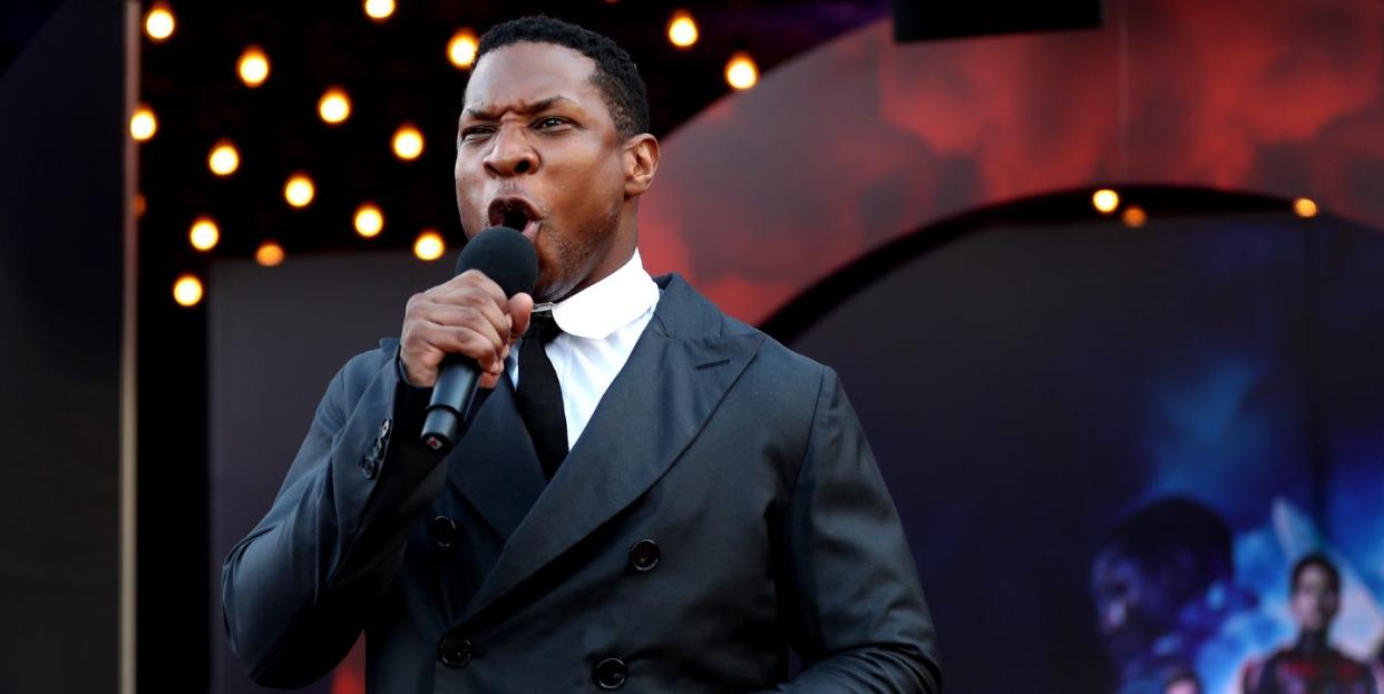 jonathan majors shouting into a microphone