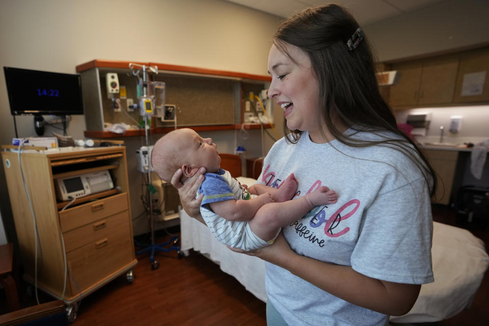 FILE - Katie O'Brien holds her son, Bennett, on Tuesday, Aug. 29, 2023, in the birthing room where she delivered him in July at the Henry County Medical Center in Paris, Tenn. By the end of the century, the U.S. population will be declining without substantial immigration, senior citizens will outnumber children and the share of white residents who aren't Hispanic will be less than half of the population, according to population projections released Thursday, Nov. 9, 2023 by the U.S. Census Bureau. (AP Photo/Mark Humphrey, File)