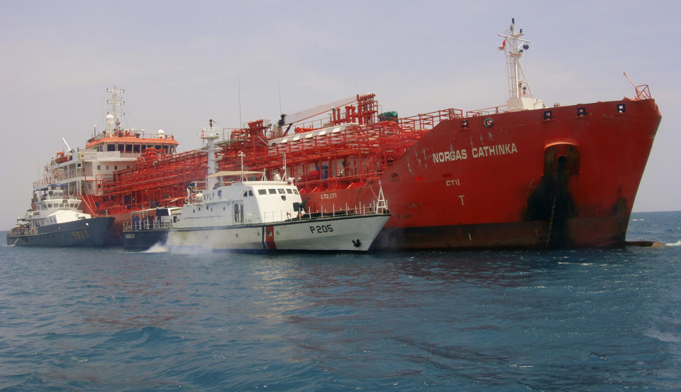 South-African flagged tanker Norgas Cathinka is escorted by Indonesian police and custom boats near Bakauheni port in Lampung province, Wednesday, Sept. 26, 2012. The tanker collided with a passenger ferry early Wednesday morning, killing at least eight people, officials said. (AP Photo)