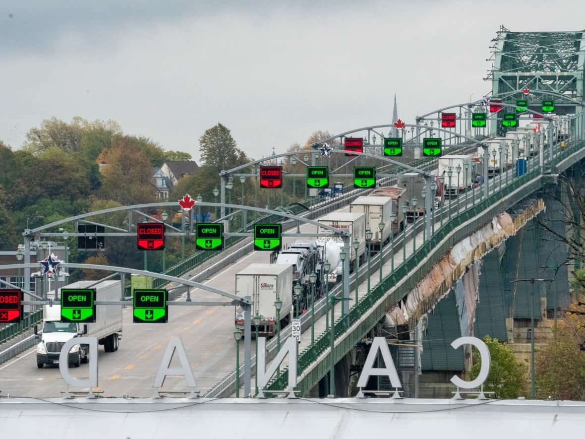 Trucks line up to enter the United States on the Peace Bridge in Fort Erie, Ont. Trucks are responsible for moving about 70 per cent of all trade between Canada and the U.S. (Frank Gunn/The Canadian Press - image credit)