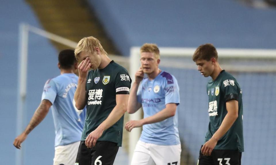 Ben Mee reacts as he leaves the field after a shameful night for Burnley.