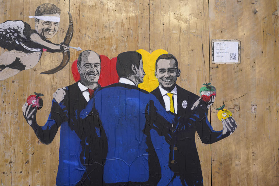 A graffitti by Italian street artist TvBoy shows from left former Premier Matteo Renzi, Democratic Party leader Nicola Zingaretti, Premier Giuseppe Conte, and 5-Star Movement's Luigi Di Maio, in Rome, Friday, Sept. 6, 2019. Conte's first, 14-month-long coalition imploded last month after the right-wing League, led by Matteo Salvini, pulled out of a government it had formed with the populist 5-Star Movement, in the new government, the staunchly pro-Europe, center-left Democratic Party replaced the League as junior coalition partner. (AP Photo/Andrew Medichini)