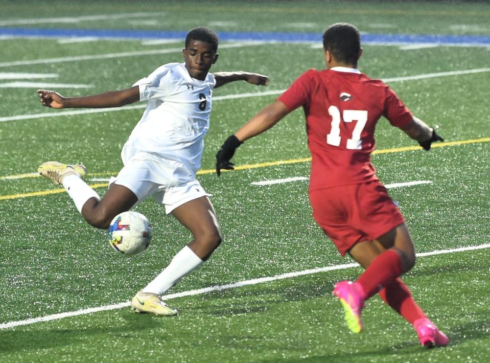 Abilene High's Sammy Batendji, left, scores the game's first goal 6:57 into the second half against Wichita Falls. AHS beat the Coyotes 2-1 on a cold, rainy night at the TNT tournament Thursday at Shotwell Stadium.