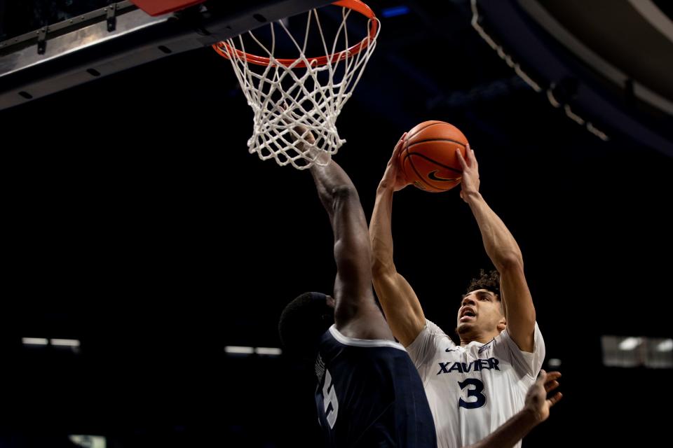 Xavier Musketeers guard Colby Jones (3) hits a shot around Georgetown Hoyas center Timothy Ighoefe (5) in the first half of the NCAA men's Basketball game, Saturday, March 5, 2022, at Cintas Center in Cincinnati. 