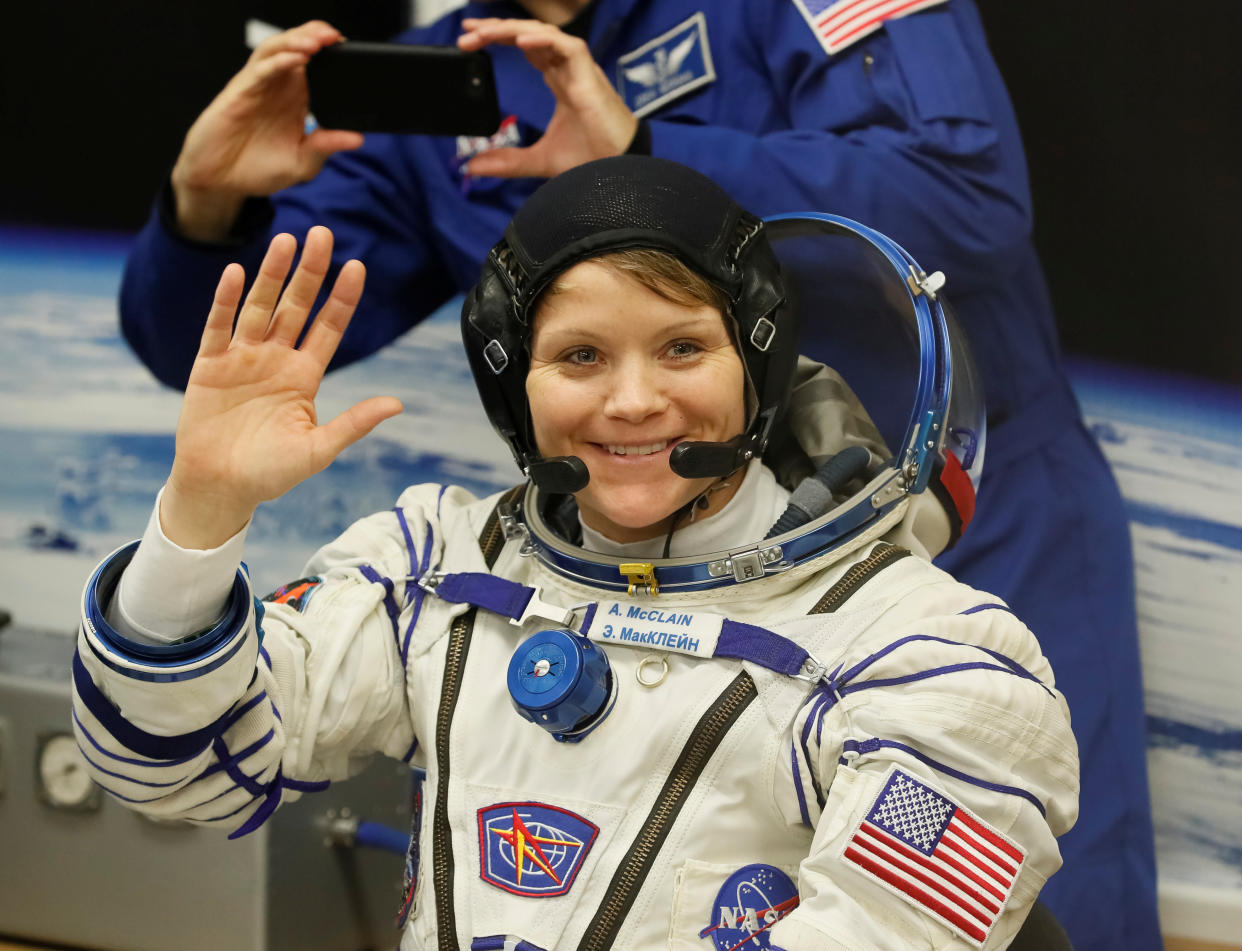 The International Space Station (ISS) crew member Anne McClain of the U.S. waves after donning space suits shortly before their launch at the Baikonur Cosmodrome, Kazakhstan December 3, 2018.  REUTERS/Shamil Zhumatov