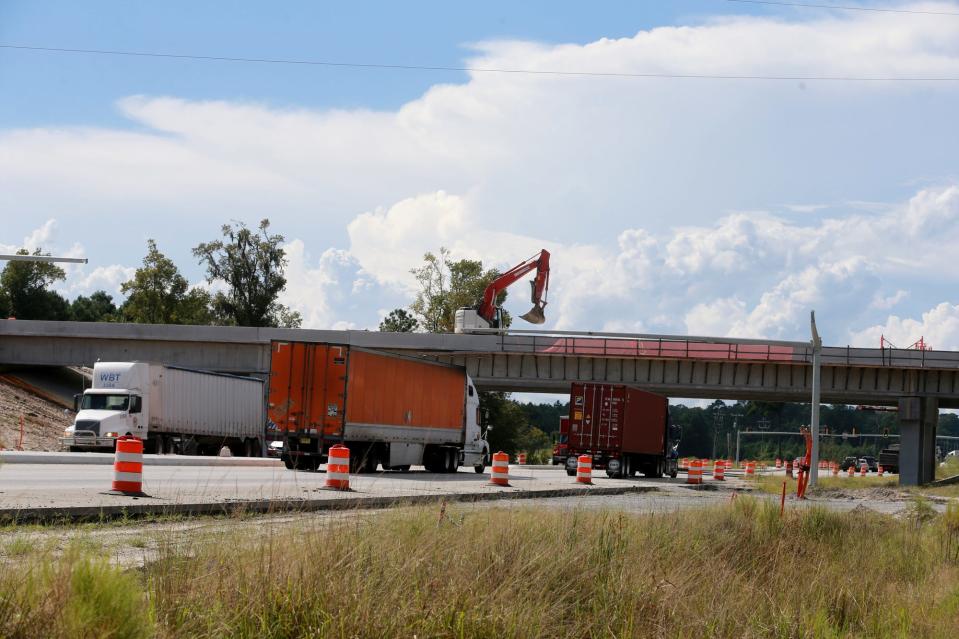 An excavator rolls across the Jimmy Deloach overpass in a photo from 2021.