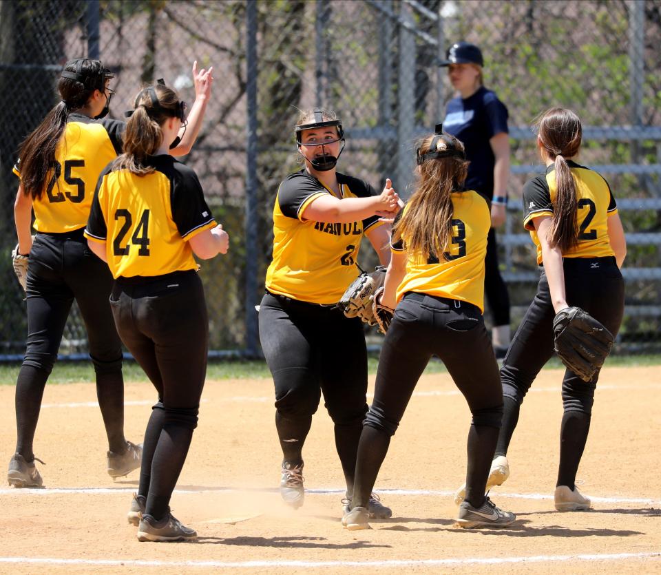 Nanuet pitcher Kami DeGaetani, center, hand slaps her teammates, during their girls softball game against Suffern, at Suffern High School, April 30, 2022. Nanuet beat Suffern, 8-0.